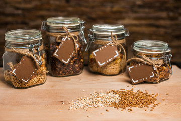 Homemade granola in glass jar on wooden table