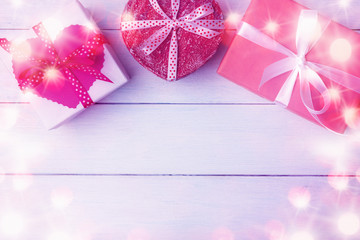 Gift boxes over light wooden background