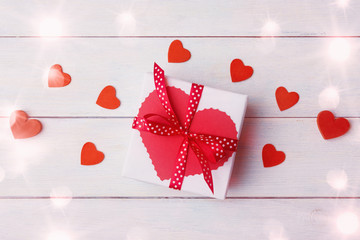 Valentine's Day decorated gift box over white wooden background