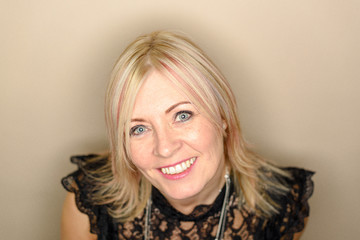 Fototapeta premium Caucasian woman mid 40's with pink dye in hair wearing a black top