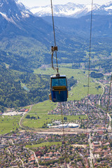 Steep climb by an overhead cable car towards the top of the Wank mountain in...