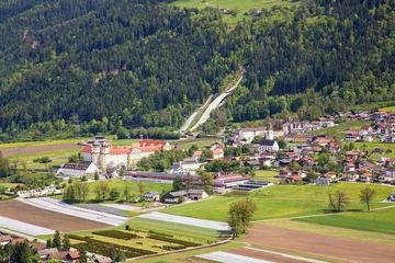 Fotobehang Panoramic bird's eye view of the city of Stams and its abbey and ski jump in Tyrol, Austria (Europe). © Studio F.