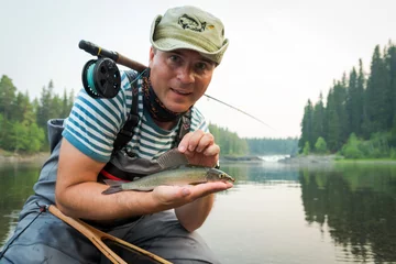 Fotobehang Happy angler with grayling fishing trophy © Piotr Wawrzyniuk