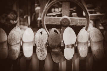 Old wooden dutch clogs on in house. Holland, Netherlands . Image in sepia color style