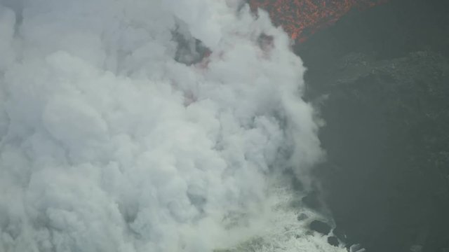 Aerial view of molten volcanic lava entering ocean
