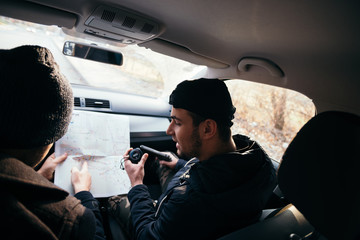 Bank robbers,planning their next hit while holding a gun and counting on a stop watch the time they...