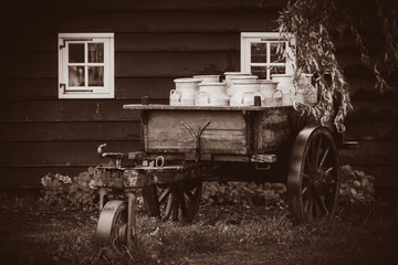 old traditional Dutch cans in a carriage in village. Holland, Netherlands . Image in sepia color...
