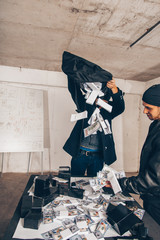 Burglars enjoying with the stolen money emptying the bag