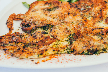 Closeup of fried omelette on a white plate - Mediterranean breakfast in a restaurant - Provence dish