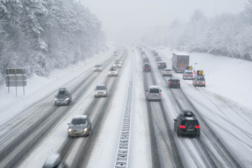 snow covered highway in austria with cars out of focus - Powered by Adobe