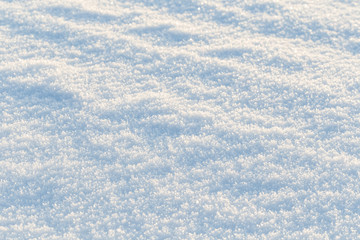Close-up of fresh snow on the ground on a sunny day, good as a winter season background.