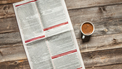 Fototapeta premium Reading newspaper on wooden background