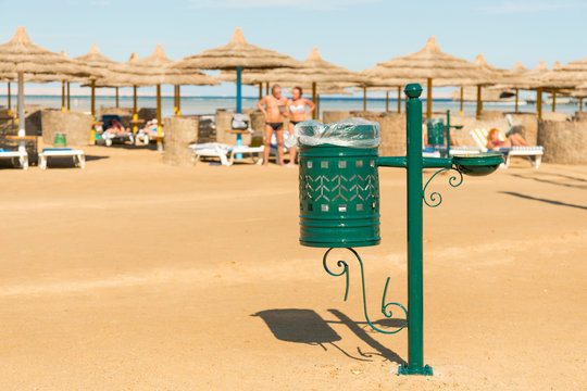 Green urn on the beach