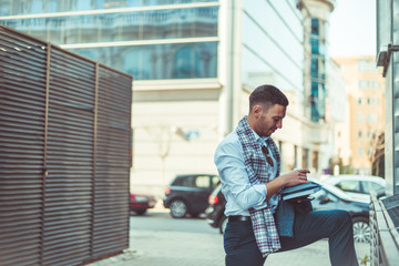 Man in suit standing and reading his notebook