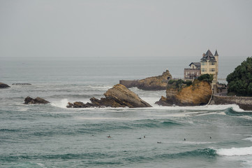 FRANCE, BIARRITZ - SEPTEMBER 18, 2018: Modern castle situated by the sea with cliffs and seagulls...