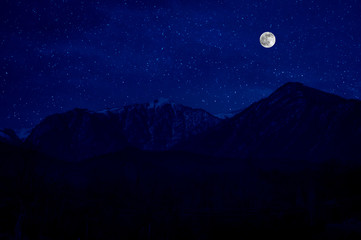Naklejka na ściany i meble Mountain Road through the forest on a full moon night. Scenic night landscape of dark blue sky with moon. Azerbaijan