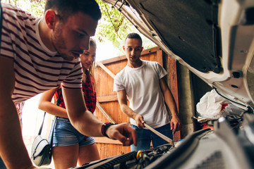 Guy fixing his venichle in garage