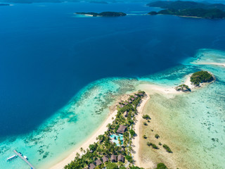 Fototapeta na wymiar Aerial view of tropical island Bulalacao. Beautiful tropical island with white sandy beach, palm trees and green hills. Travel tropical concept. Palawan, Philippines