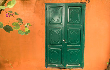 a garden shed with a green door