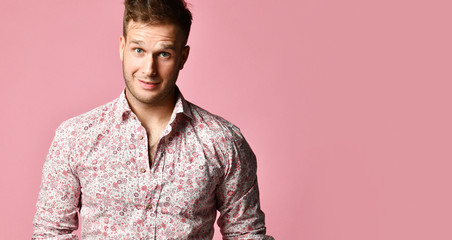 Young successful happy smiling business man in shirt standing posing on pink 