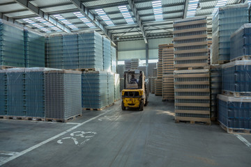 Large modern warehouse with forklifts. Loaders in modern storehouse. Interior of a modern...