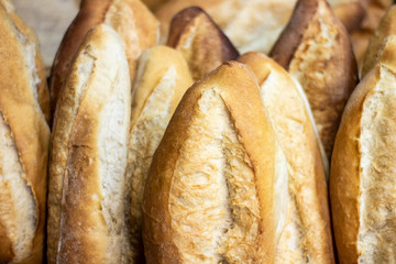 Display of handmade bread loaves on the counter top of a modern bakery to entice customers to buy