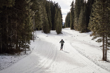 handosme middle aged man cross country skiing in his free time