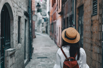 woman walking by tight streets of kotor