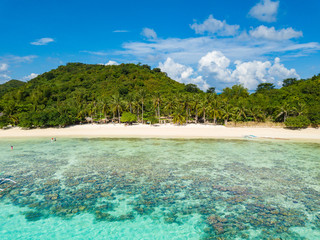 Aerial view of tropical  beach of island Bulalacao. Beautiful tropical island with white sandy beach, palm trees and green hills. Travel tropical concept. Palawan, Philippines
