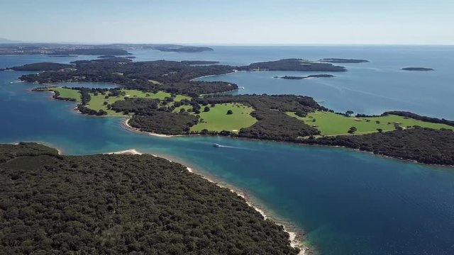 Flight over desert islands and colorful sea, Brijuni park, Croatia