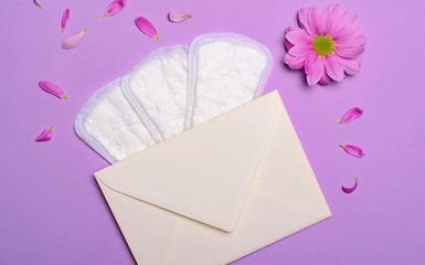 Woman's Sanitary Pads, Envelope and Gerbera Daisy Flower, Feminine Hygiene Concept