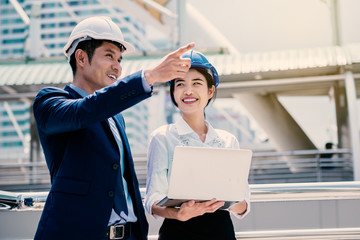 Happy woman working with her manager as trainee engineer