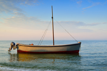 Fototapeta premium Fishing boats moored near the shore at sunset background