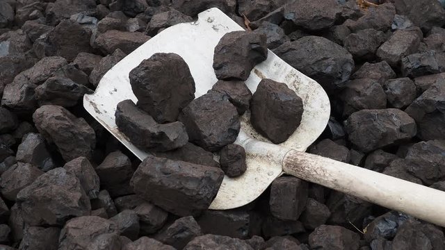 Shovel and coal. A pile of brown coal with a shovel, lignite storage.