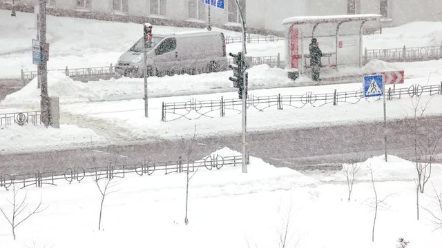 Car traffic in winter city. Urban scene of city life in winter seson. Safety on the road in winter.