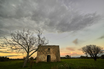 Ancient rural house in the magic of twilight