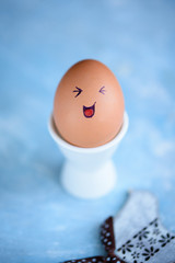 Funny little donkey on Easter eggs on a blue background. Different faces on the eggs. Emotions....