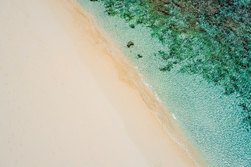 Beautiful tropical white empty beach and sea waves seen from above. Seychelles beach aerial view