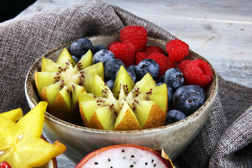 fruit bowl. Bowl of healthy fresh fruit salad on rustic background