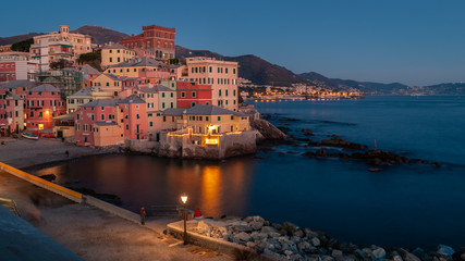 Obraz premium Genoa, Italy. Village of Boccadasse taken at the blue hour on a winter evening. Reflections of the lights on the sea. Boccadasse is an ancient maritime village with pastel shades