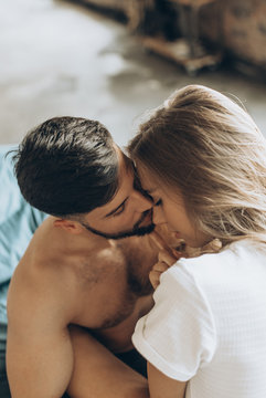 beautiful loving couple kissing in bed