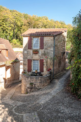 Medieval village of Aquitaine with its stone houses in the south of France on a cloudy day.