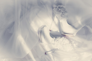 .Beautiful bride shoes on a white fot.