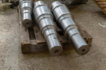Metal shafts stacked in a row in stock
