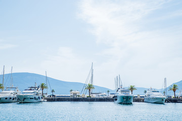 Naklejka premium yachts in montenegro bay. mountains on background