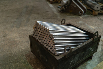 Metal long rollers lined up in an iron box