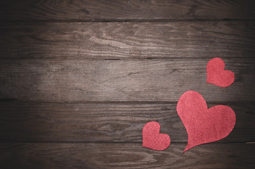 Heart made of felt on a wooden table. Frame to the day of Saint Valentine.