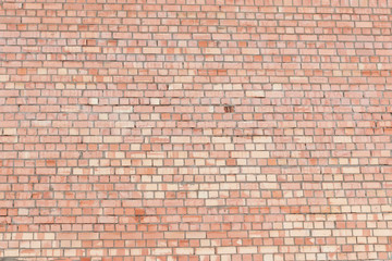 Red vintage brick wall. Old broken industrial texture. Background. Grunge street exterior.