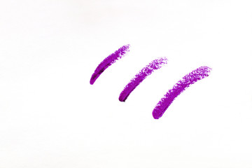Set of smears of violet lipsticks close-up isolated on white background. Make-up, beauty.