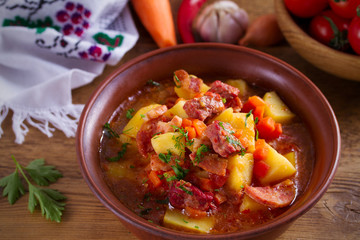 Delisious homemade stew. Goulash soup in a bowl on wooden table. horizontal.